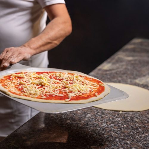 front-view-chef-preparing-pizza (1)